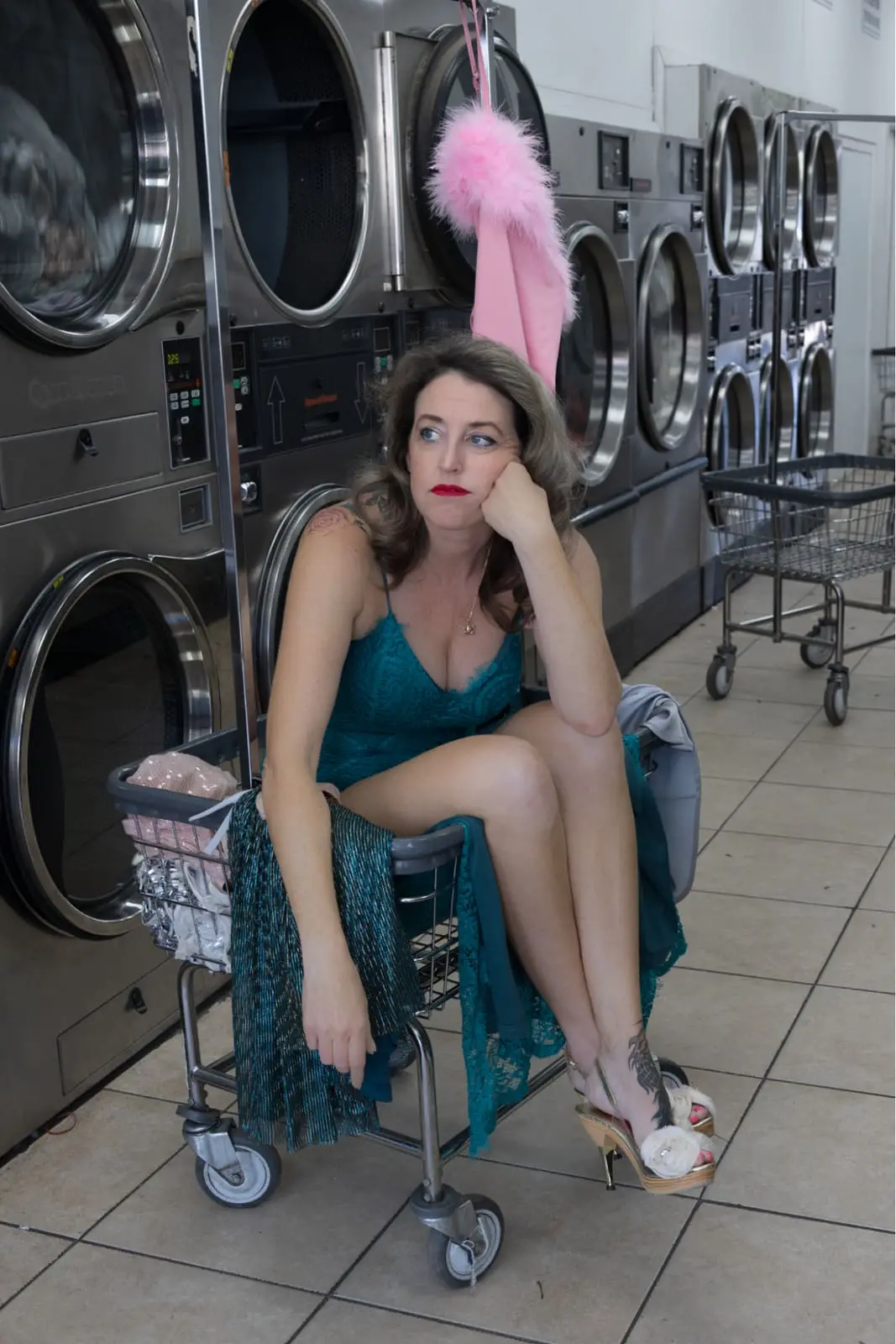 Ashley E. Norton seated in a laundromat portrait.