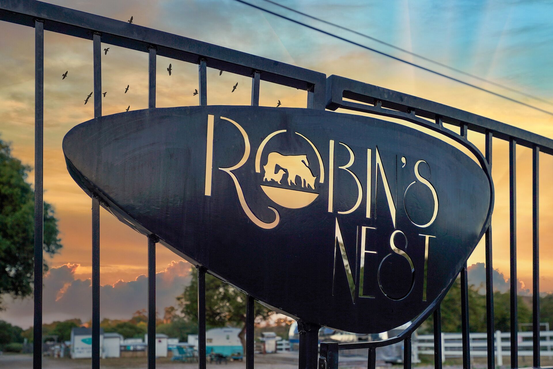 Robin's Nest Rescue entrance sign at sunset.