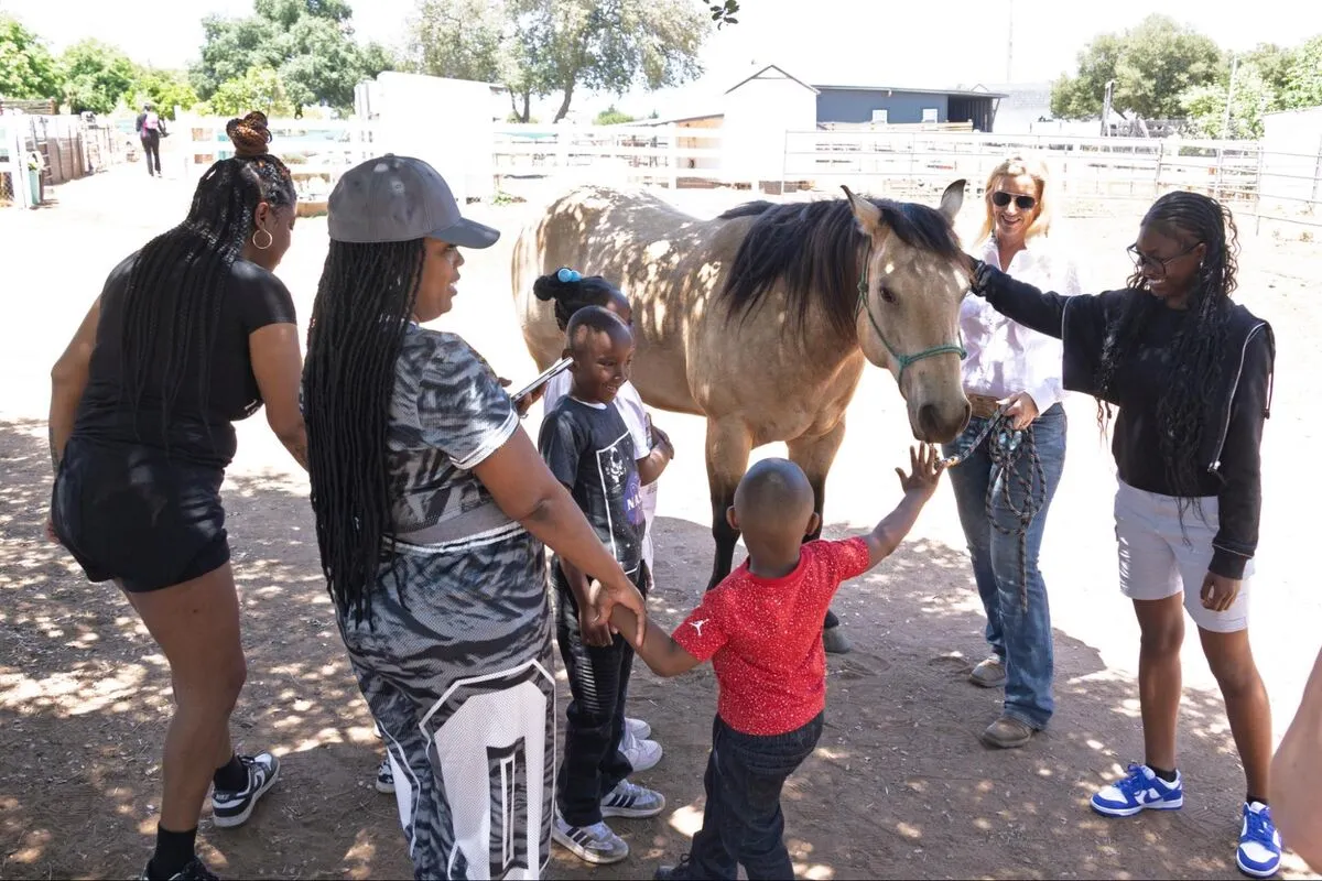 A family connecting together with sanctuary animals during a Side by Side session.