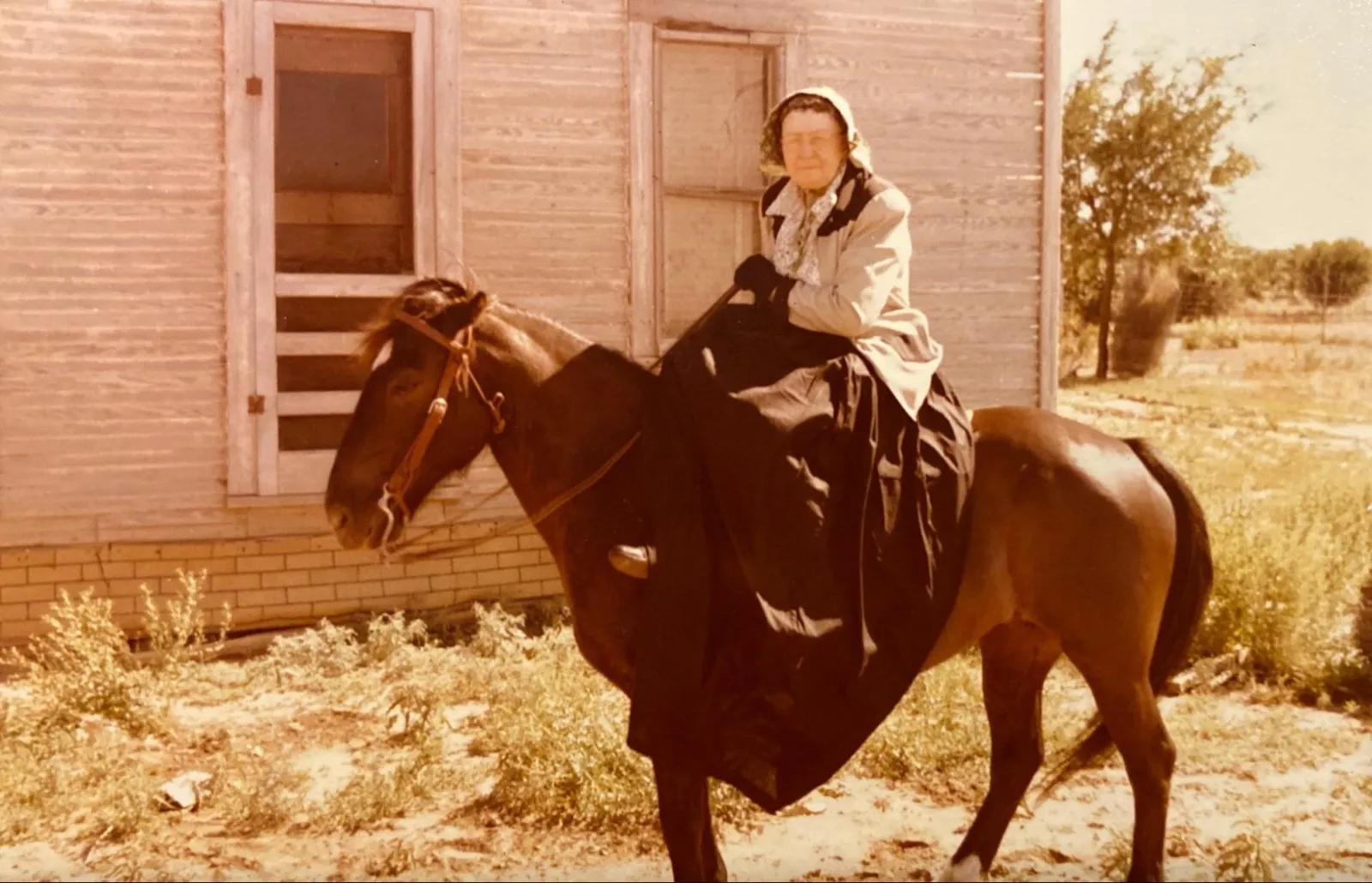 A woman riding side saddle on a horse in 1956 — Annie Almeda Allen Carr at age 70.