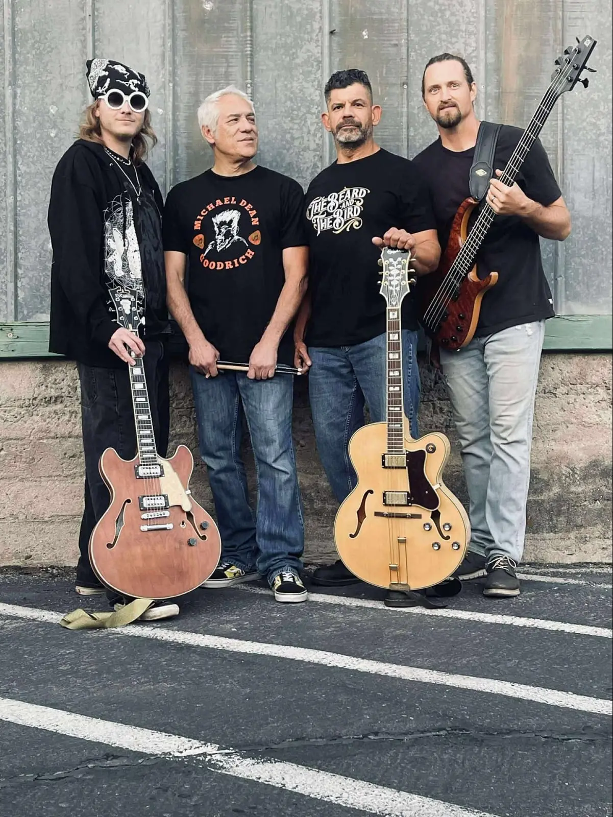 MDG & The Del Sols band members standing with guitars.