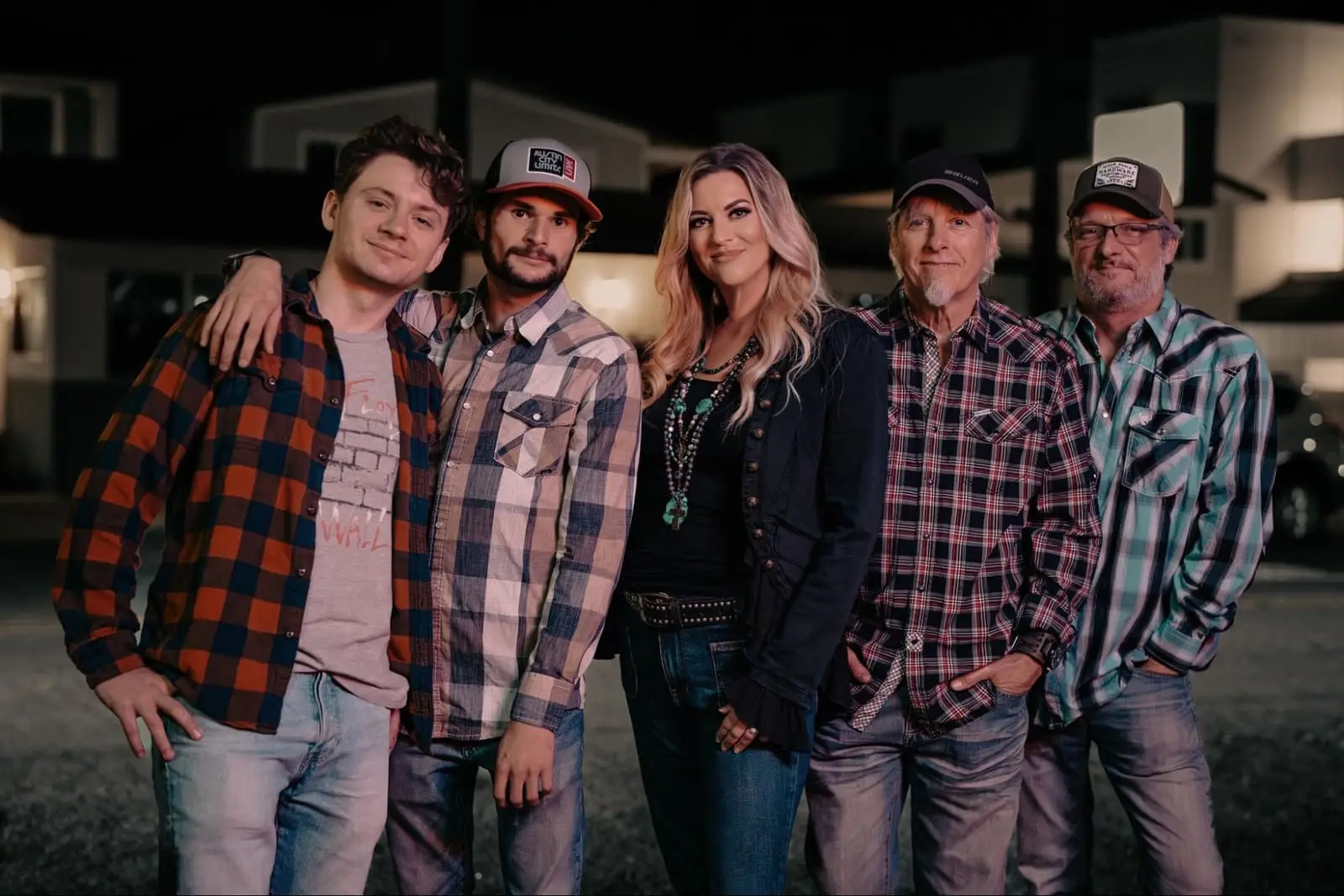 Southern Mayhem band members standing together at night.