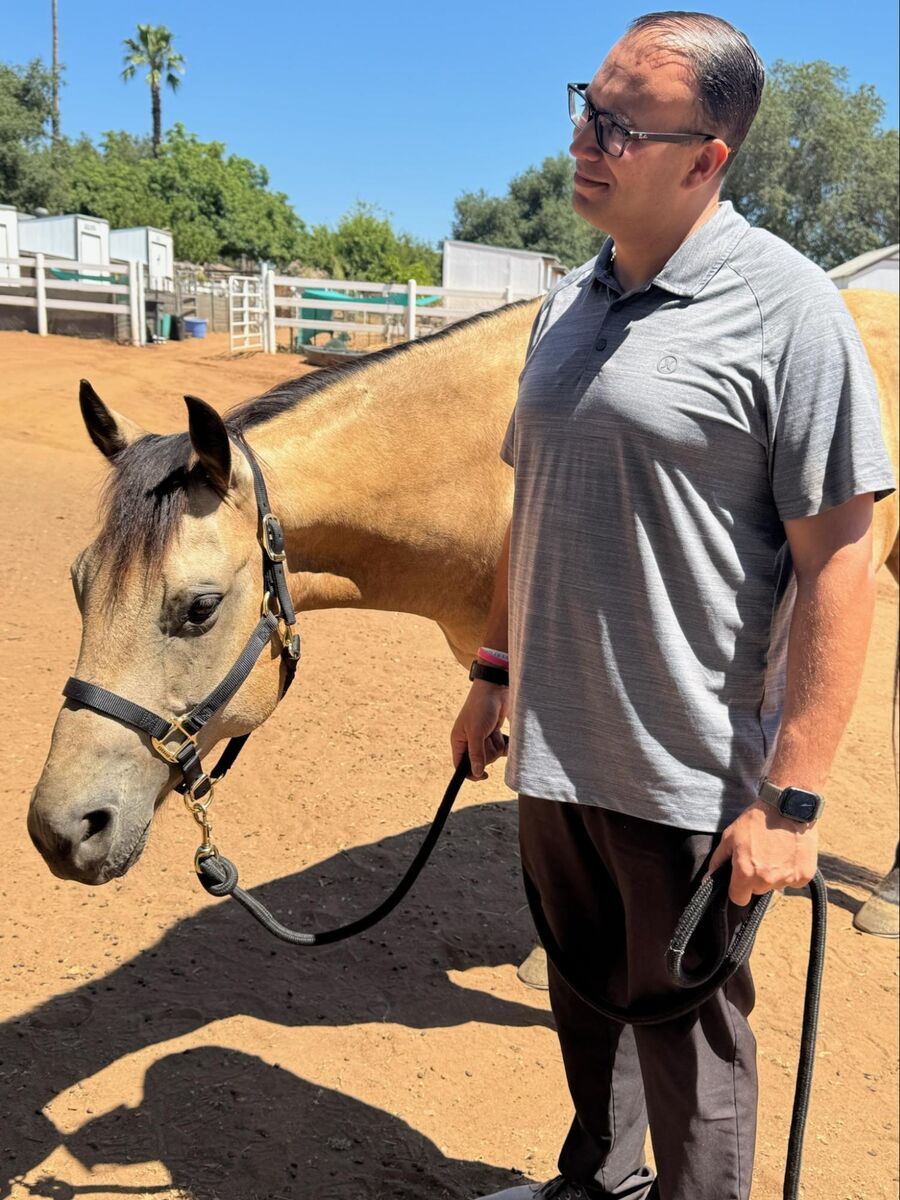 A veteran sharing a calm, grounding moment with a sanctuary animal.